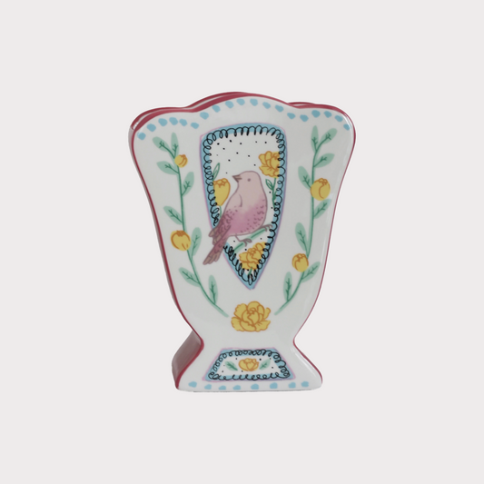 A tulip-shaped vase, with a surface hand-painted with pink nightingales, blue windows, and yellow roses. The side of the vase is painted in soft pink. This vase is inspired by Oscar Wilde’s "The Nightingale and the Rose," beautifully blending artistic elements to capture the essence of the story.